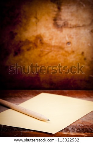 Vintage envelope background with pencil on a dark grunge background in shallow focus