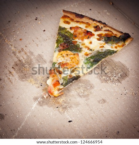 Pizza slice last one left in the pizza box
