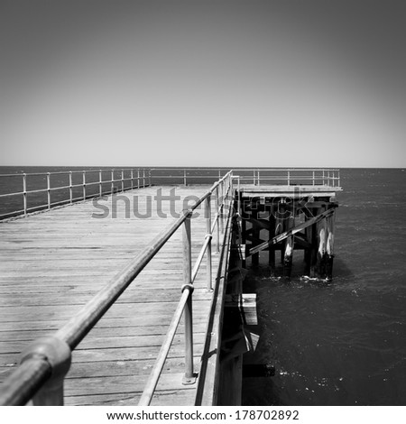 Long wooden jetty stretches out into clear water at Stenhouse Bay, South Australia