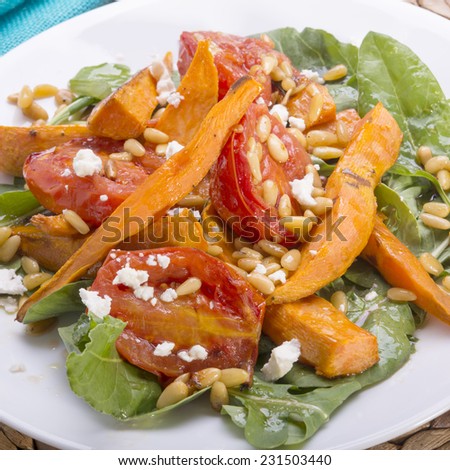 Roast pumpkin salad with tomatoes, pine nuts, feta and dressing, all gluten free
