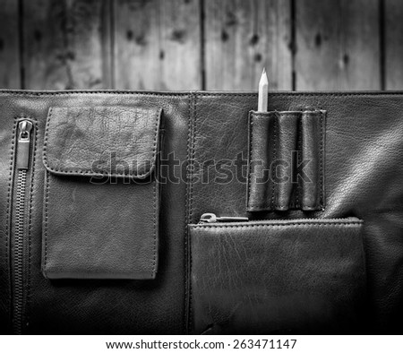 A man\'s business briefcase bag, leather satchel with a pencil in black and white