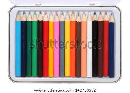 Set of color pencils in metal case on a white background