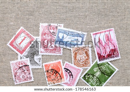 Postage stamps on burlap background