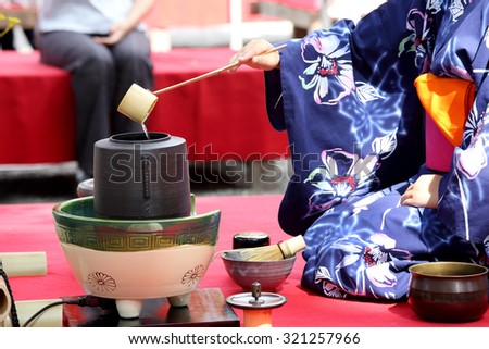 KAGAWA, JAPAN - SEPTEMBER 23, 2015: Japanese woman in traditional kimono prepares the tea ceremony at garden of the Hagiwara Temple on September 23, 2015 in Kagawa Japan.