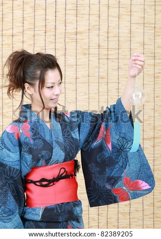 Japanese woman in traditional clothes of Kimono with wind bell