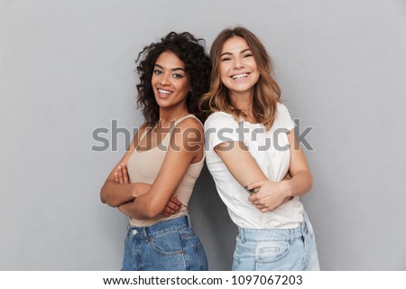 Image, Stock Photo Two teenager girls standing and looking at their smartphone