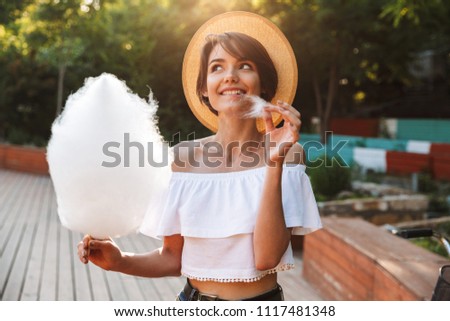 Similar – Image, Stock Photo Cheerful girl eating cotton candy on street