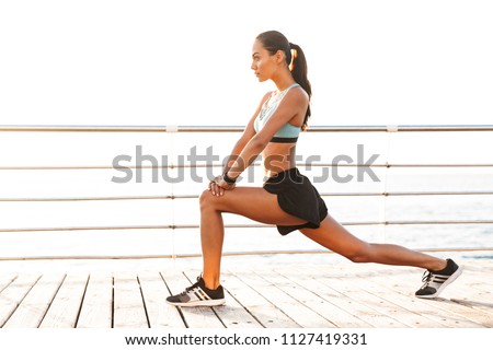 Similar – Image, Stock Photo Sportswoman stretching legs on stadium