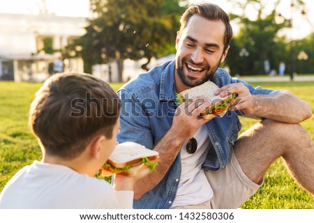 Similar – Image, Stock Photo Child eats sandwich outdoor