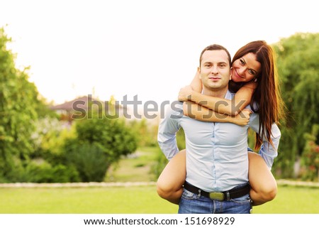 Happy woman jumped on man's back