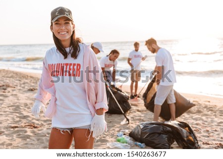 Similar – Image, Stock Photo Young woman cleaning beach area and showing plastic bottle lids in hand