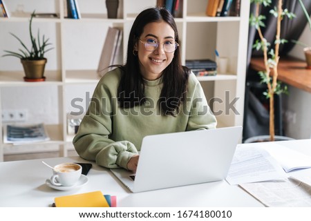 Similar – Image, Stock Photo Cheerful woman reading notebook in office