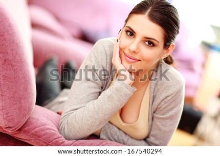 Young beautiful woman lying on the couch at home