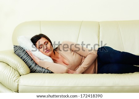 Young beautiful woman sleeping on the sofa at home