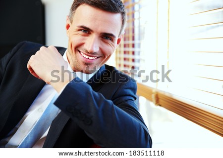 Portrait of a handsome happy businessman in suit
