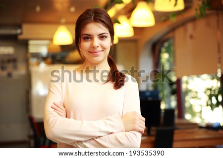 Portrait of a young smiling woman with arms folded