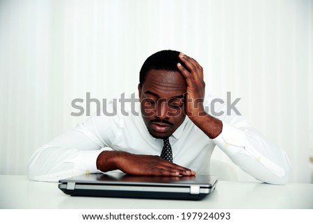 African man sleeping at his workplace in office