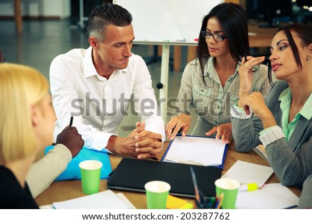 Business people having meeting around table in office