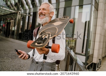 Similar – Image, Stock Photo Smiling man with longboard on street