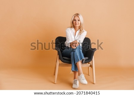 Similar – Image, Stock Photo woman sitting on a purple sofa and painting her lips red