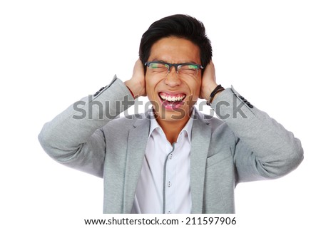 Portrait of man holding hands to ears covering to shut out noise