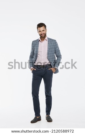 Front view of young caucasian businessman with hands in pockets looking at camera. Smiling man wearing formal wear. Concept of modern successful man. Isolated on white background in studio. Copy space ストックフォト © 