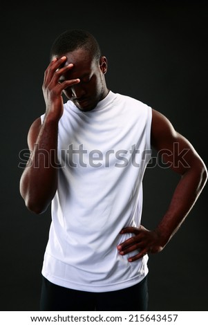 Frustrated african man over black background