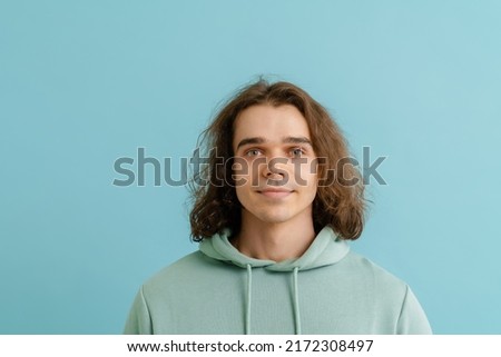 Similar – Image, Stock Photo Long haired young handsome man on a black background with a light illuminating his face, with a flirtatious expression for the camera showing a slight smile