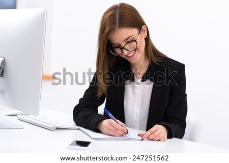 Happy attractive businesswoman working in office