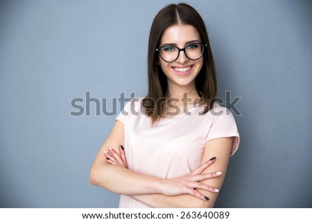 Portrait of a smiling young woman with arms folded