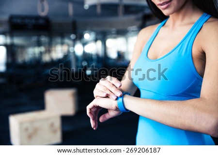 Woman using activity tracker at gym