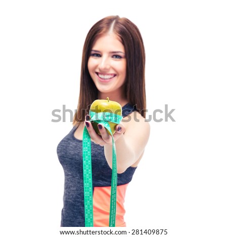 Smiling fitness woman with apple and measuring tape isolated on a white background. Focus on apple