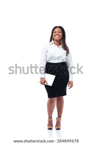 Full length portrait of a smiling afro american businesswoman holding tablet computer over whiet background. Looking at camera