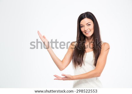 Happy young woman showing welcome gesture with hands isolated on a white background. Looking at camera