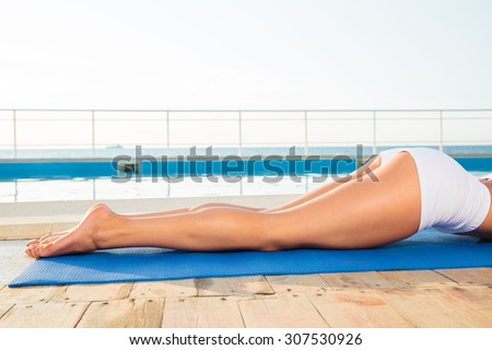Closeup portrait of a woman lying on yoga mat