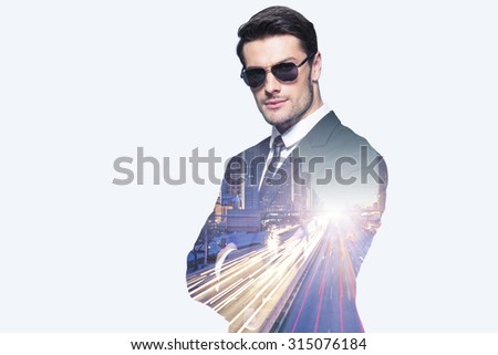 Double exposure of a businessman in sunglasses and city roads