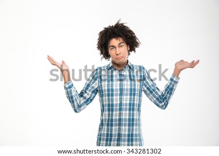 Portrait of a young afro american man shrugging shoulders isolated on a white backround Foto stock © 