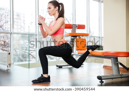 Image, Stock Photo Focused sportswoman doing squats with elastic band in apartment