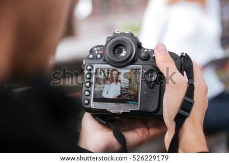 Similar – Image, Stock Photo Unrecognizable photographer taking photo on camera near wall outdoors