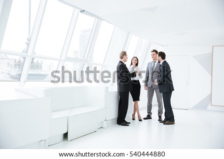 Full length portrait of Business team stand near the window in conference room ストックフォト © 