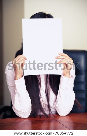 The new worker holds the white blank paper in front of her face