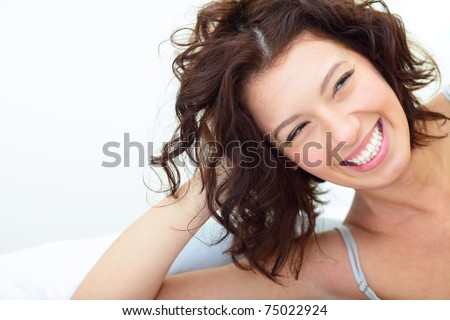 Beautiful woman lying on the sofa and laughing sincerely