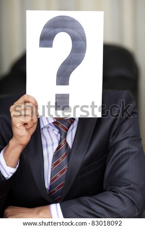 The new worker holds the white paper with question sign in front of his face