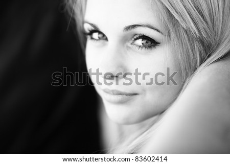 Close-up portrait of a young beautiful woman with a slight smile