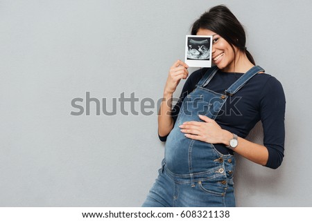 Similar – Image, Stock Photo Woman holding the ultrasound of her baby