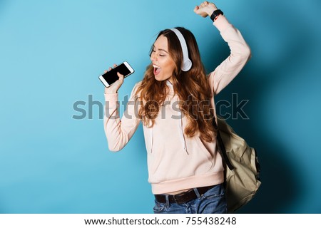 Similar – Image, Stock Photo Schoolgirls looking for audio books in school library. Students choosing books. Elementary education. Doing homework. Back to school