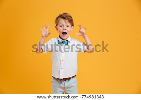 Photo of shocked little boy child standing isolated over yellow background. Looking camera. ストックフォト © 