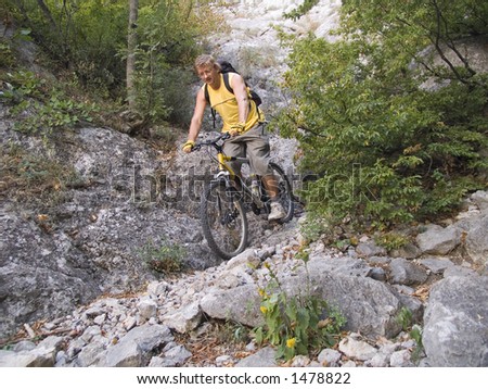The man goes down from mountains on a bicycle.