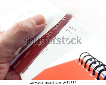 The cash voucher and credit card in a hand.