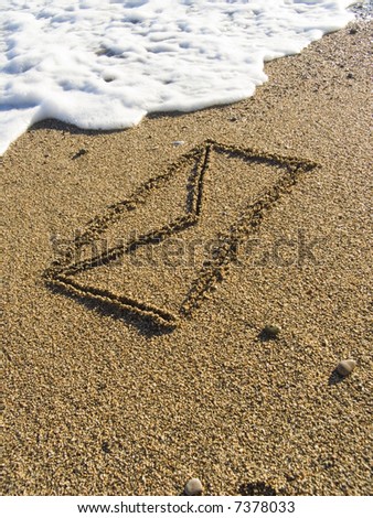 The envelope with the letter is drawn on wet sea sand